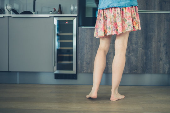 Woman with bare legs in kitchen