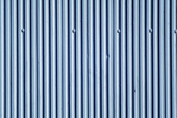 Blue color plaster wall texture with vertical pattern.