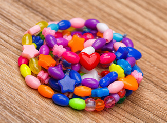 suspension of colored beads lying on wood