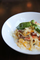 Chorizo sausage spaghetti fettuccine on wood background