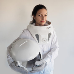 Female astronaut on a white background. Fantastic space suit. Exploration of outer space. © Ulia Koltyrina