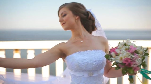 The bride dance a wedding dance on a beautiful balcony overlooking the sea