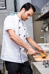 Chef preparing food in the kitchen of a restaurant  