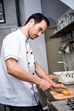 Chef preparing food in the kitchen of a restaurant  