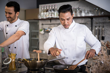 Chef preparing food in the kitchen of a restaurant  