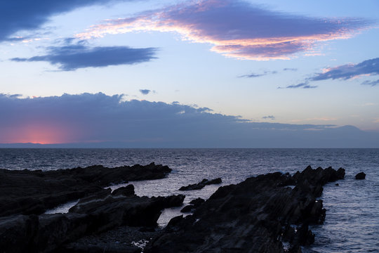 Japanese ocean coastline during the sunset velvet colors and sharp rocky shore 