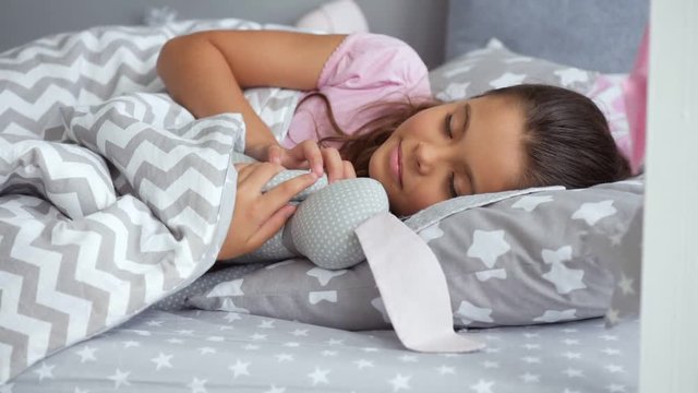 Cute little girl sleeping with her toy