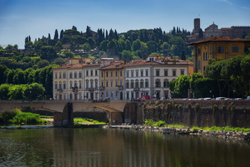 River Arno and famous bridge Ponte Vecchio (The Old Bridge) at sunny summer day. Florence, Tuscany, Italy