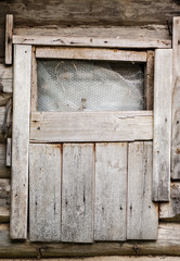 Small window in an old wooden shed, vertical