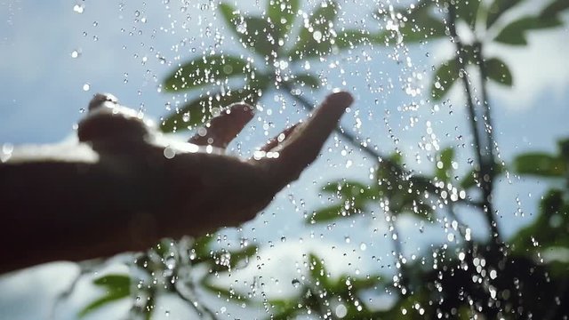 Travel, tourism, vacation, hygiene and summer holidays concept female hand washing in outdoor shower with fresh water in slow motion on the blue sky background. 1920x1080