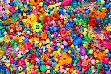 Fototapeta na wymiar Lots of colorful fusible plastic beads used for arts