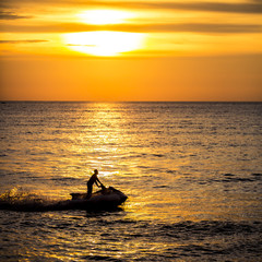 Silhouette of jetski at sunset