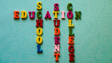The words Education, School, Student, College built of colorful wooden letters on a light table.