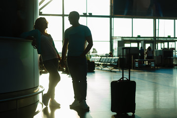 loving young couple at airport waiting for their flight