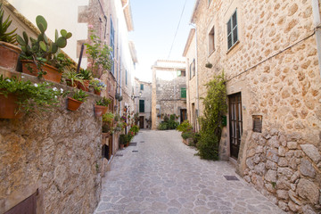 Fototapeta na wymiar Beautiful street in Valldemossa, famous old mediterranean village of Majorca Spain.