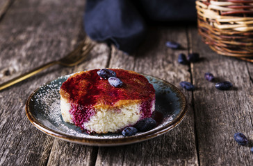 Pieces of light dietary homemade semolina cake with honeysuckle sauce on a rustic vintage wooden...