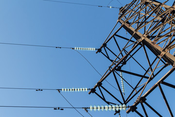 The energy of electrical wires fixed through insulators on a metal support.