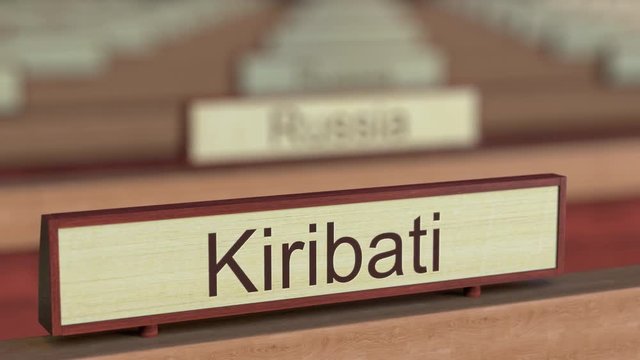 Kiribati name sign among different countries plaques at international organization. 3D rendering