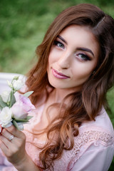 Look from above at woman with white roses in her arms