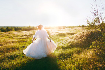 Fototapeta na wymiar Beautiful blonde bride on a walk on nature outdoors