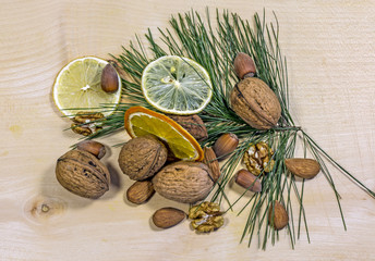 Sliced orange, walnut, cobnut, pine, twig