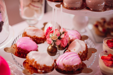 Cookies covered with pink icing and decorated with roses