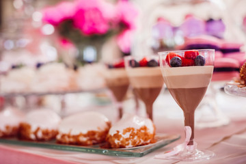 Glasses with chocolate desserts and berries