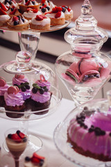 Pink cookies served in glass vases