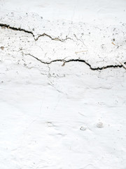 White wall texture with cracks for background.