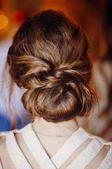 Look from behind at woman's hair made up