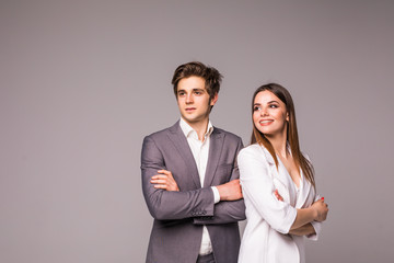Young smiling business woman and business man isolated on gray background