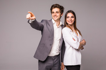 The business man and woman on a gray background. Man pointed away on gray