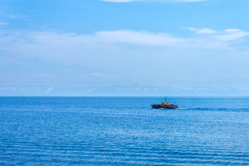 On Lake Baikal summer day floats the boat with tourists