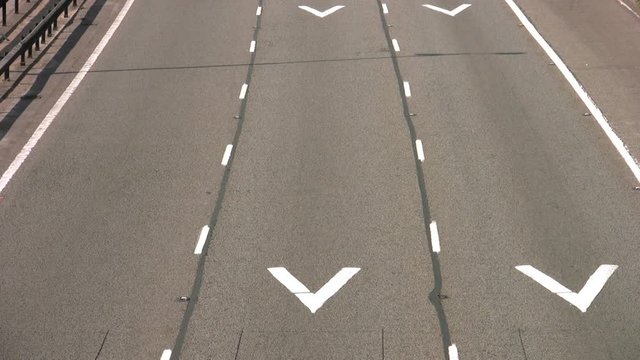 Time lapse of road traffic on the M1 Motorway Northamptonshire England UK. The motorway lanes are marked with safety chevron distance markers. 