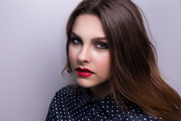 Fashionable portrait of a girl model with red lips.