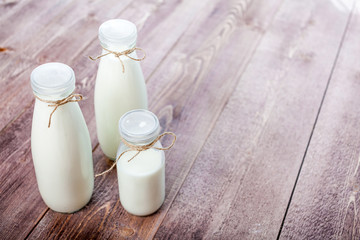 bottles of milk on a wooden rustic table. copy space