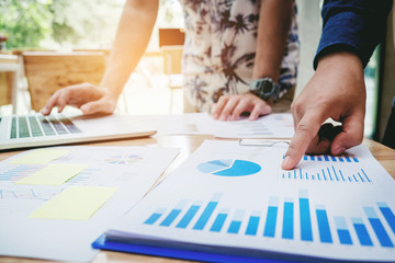 Start up business team colleagues meeting Planning Strategy Analysis discussing new plan financial on graph data new business project