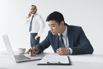 asian businessman with laptop at workplace