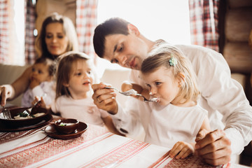 Little girl looks thoughtful eating the dumplings