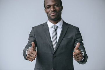 african american businessman showing thumbs up