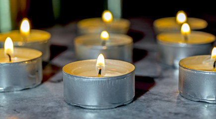 Tea candle, burning, solemn