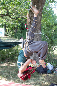Shibari in nature in summer. Bound young girl.