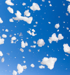 Obraz na płótnie Canvas White foam against the blue sky as background