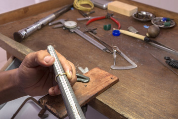 measuring the size of a ring,gold smith making