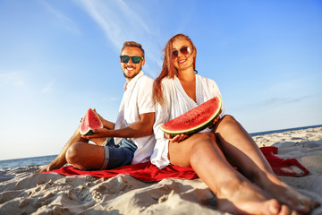 Fototapeta premium lovers on beach and water melon 