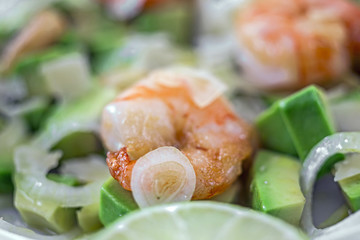 Salad of Avocado, fruit like butter, olive oil, onion, garlic, plate, prawn