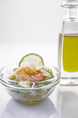 Salad of Avocado, fruit like butter, olive oil, onion, garlic, plate, prawn