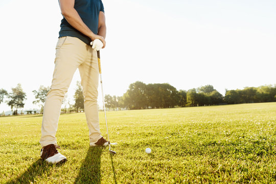 Cropped image of a golfer getting ready
