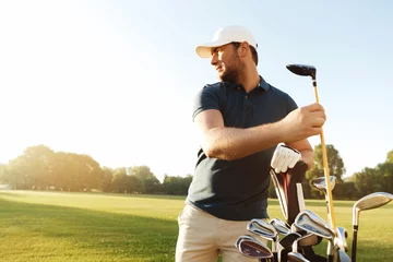 Foto auf Acrylglas Man golfer taking out the golf club from a bag © Drobot Dean