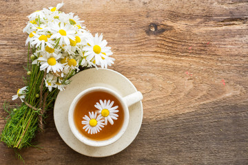 cup of herbal chamomile tea with camomile dry blossoms, dried camomile flowers. doctor treatment and prevention of immune concept, medicine - folk, alternative, complementary, traditional medicine 